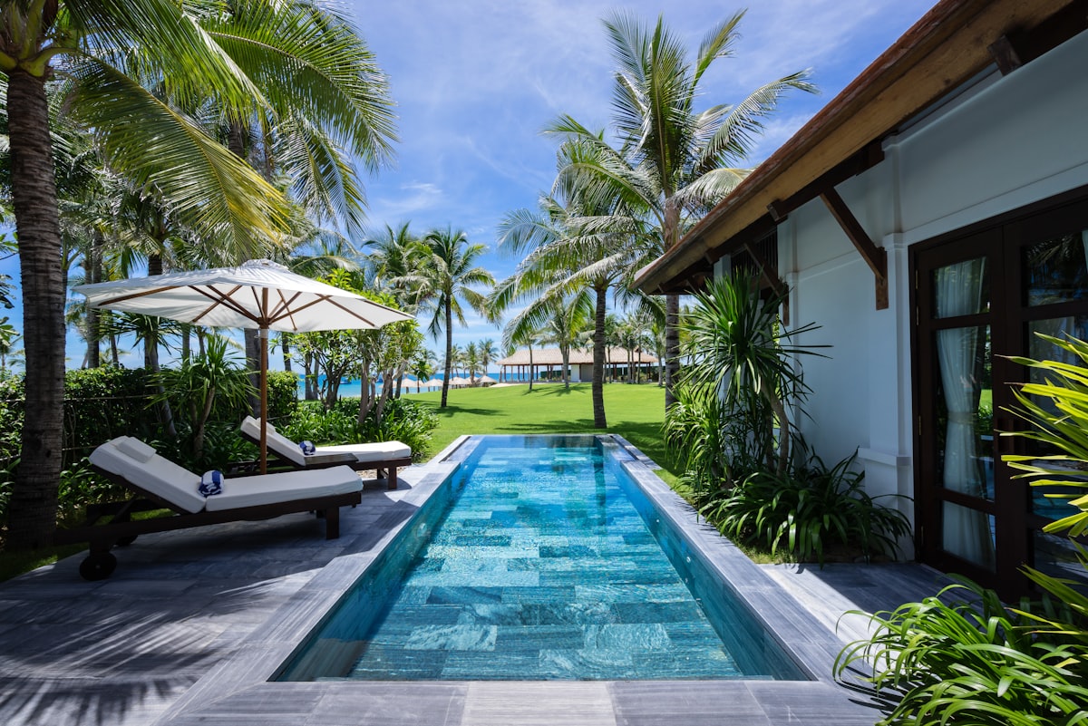 A beachfront villa with a private pool at golden hour